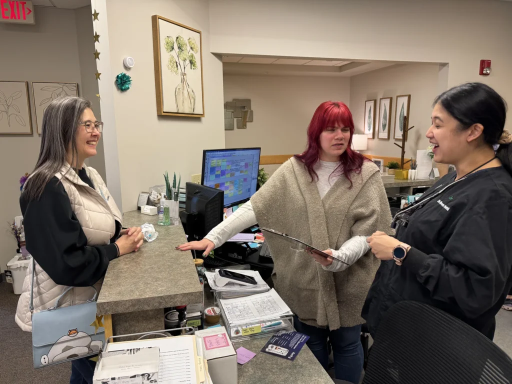The Life Bloom Dental front desk team helping a patient at check-in