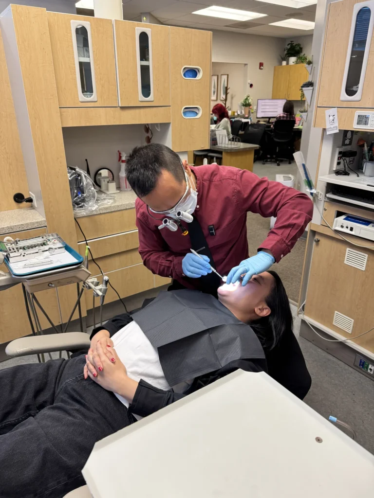 Dr. Daniel Cho examining a patient at Life Bloom Dental
