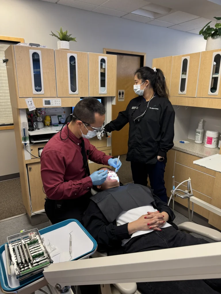 Dr. Cho treating a patient with his assistant