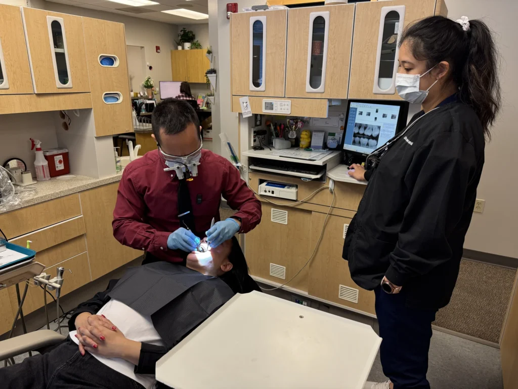 Dr. Cho treating a patient with his assistant
