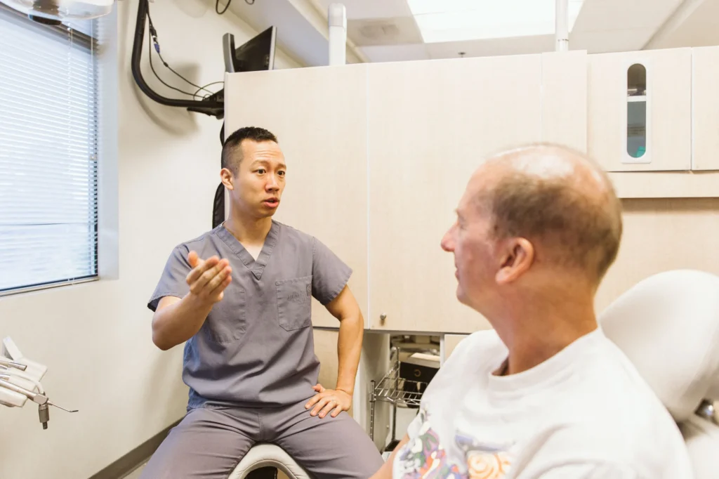 Dr. Cho chatting with a relaxed patient after treatment