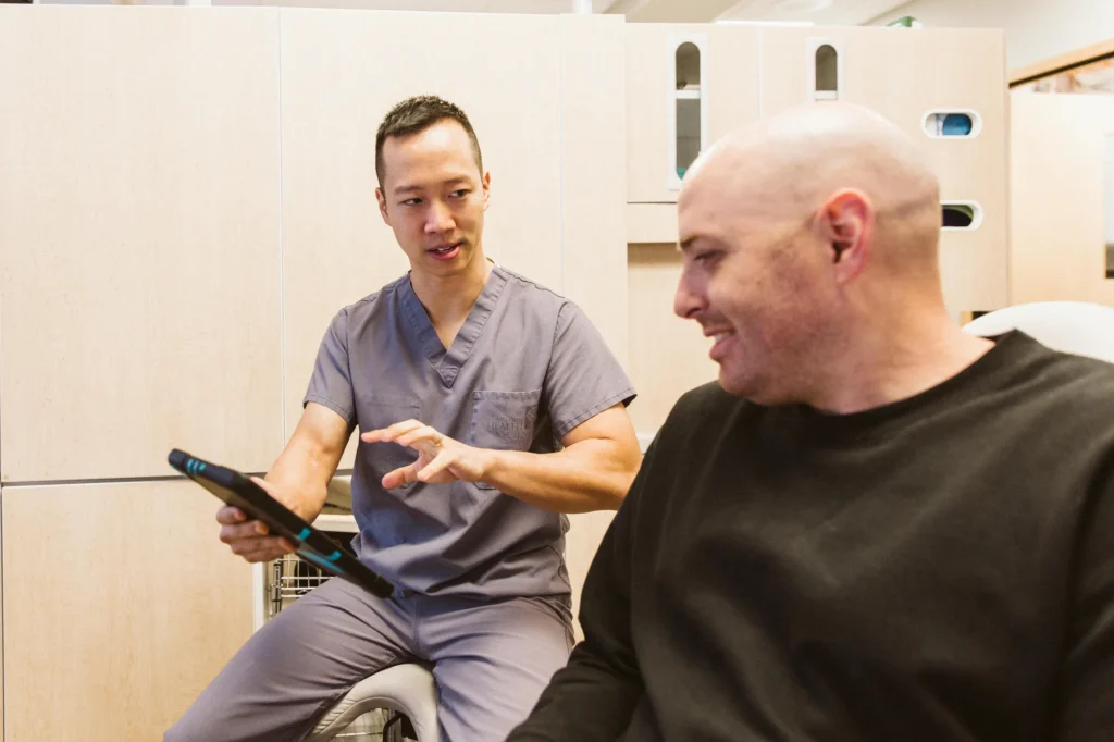 Dr. Cho going over a plan with a patient on a tablet