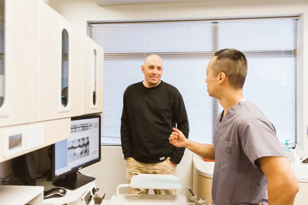 Dr. Cho showing a patient an X-ray on the monitor