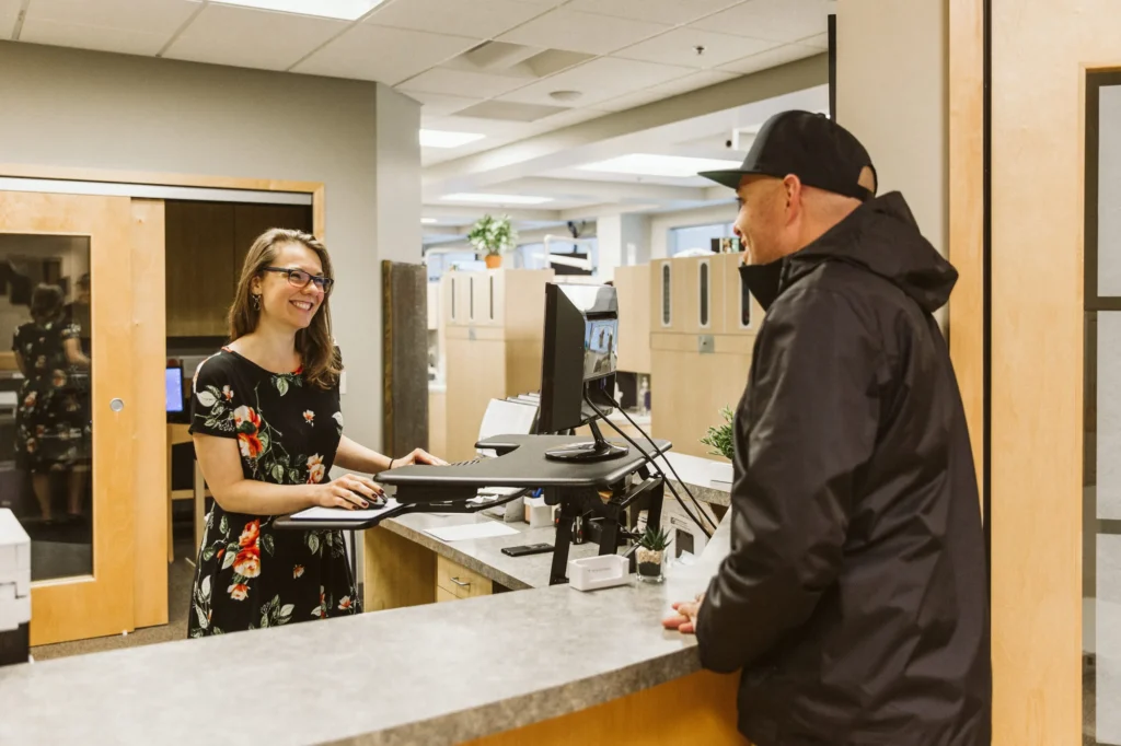 A patient checking in with the front desk team