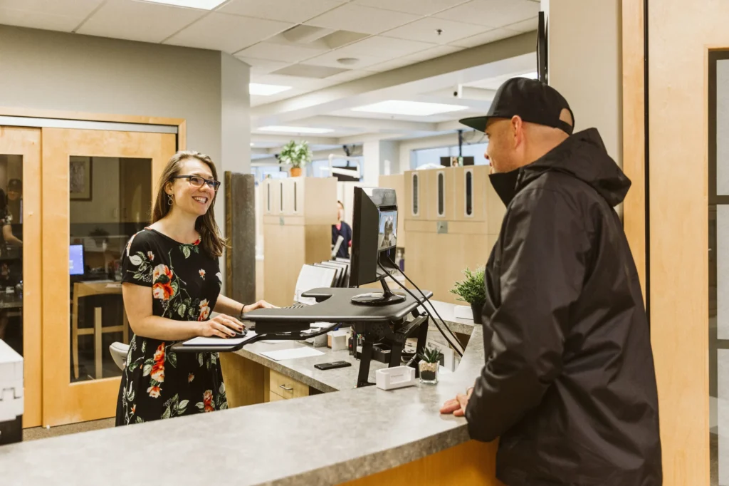 A patient checking in with the front desk team
