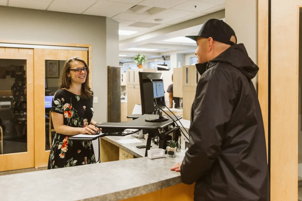 A patient talking with the front desk team at check-in
