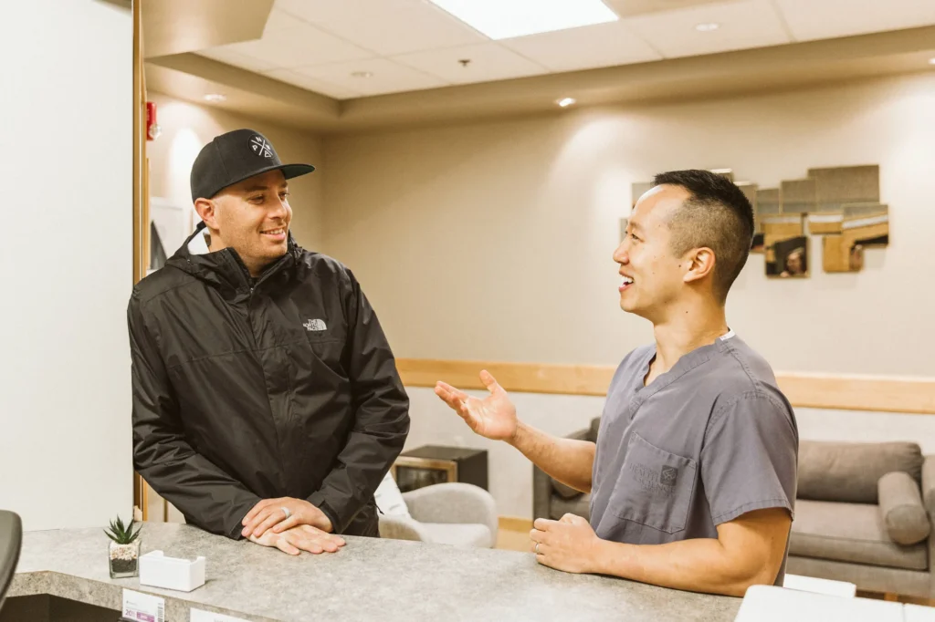 Dr. Cho talking with a patient at the front desk