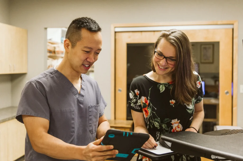 Dr. Cho going over a treatment plan with a patient on a tablet