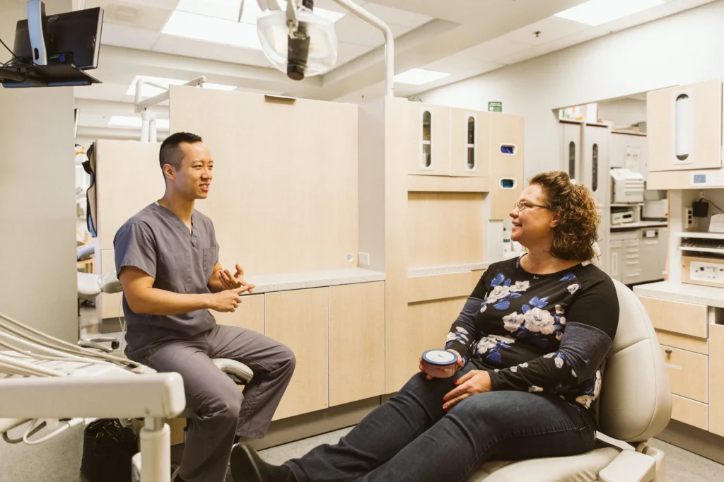 Dr. Cho talking with a patient in the operatory
