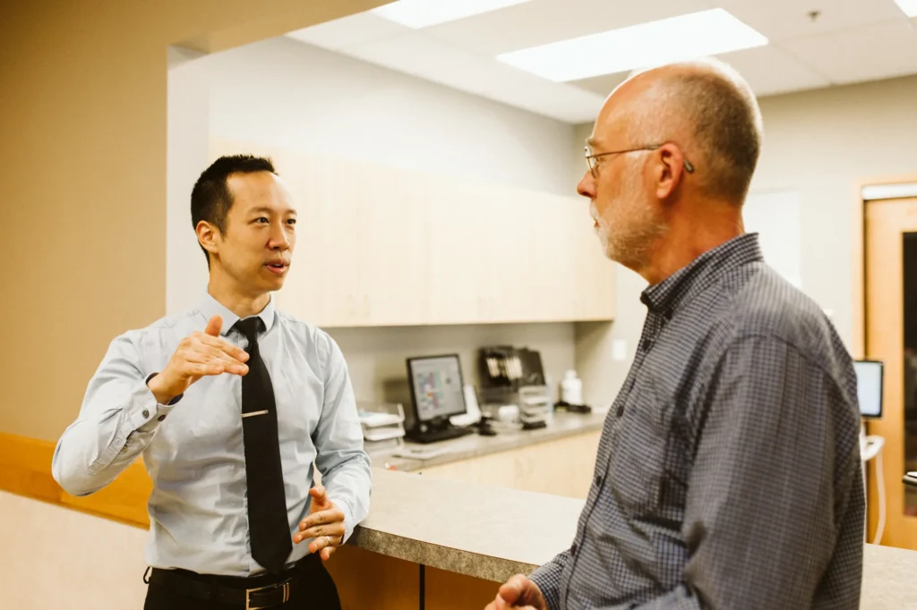 Dr. Cho talking with a patient in the office