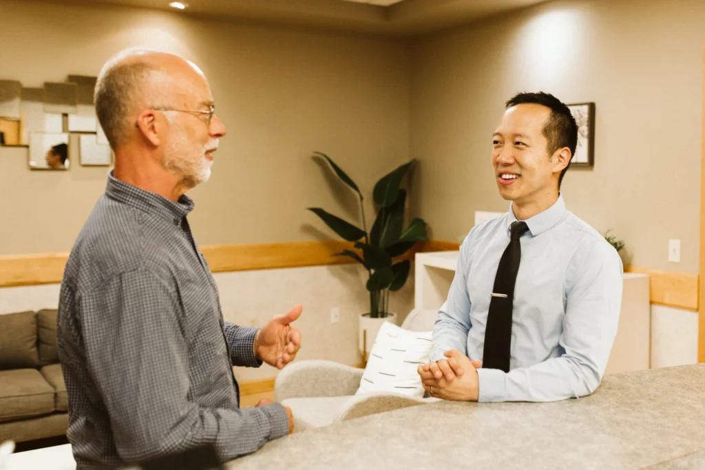 Dr. Cho talking with a patient in the lounge