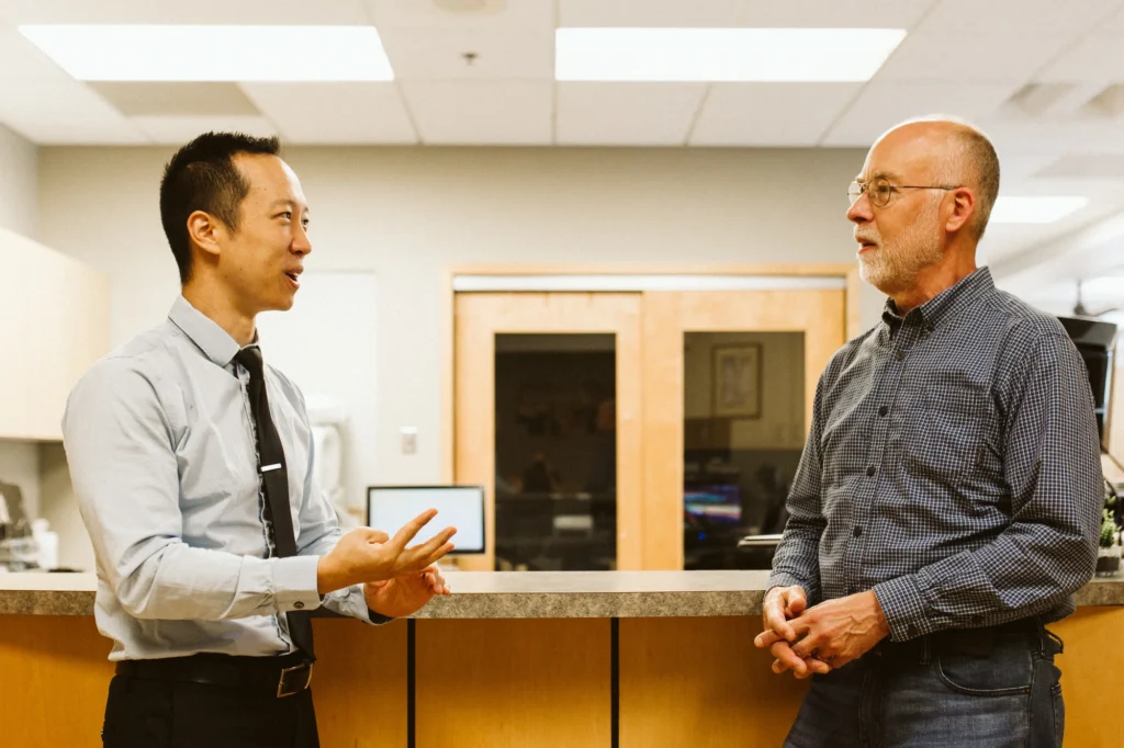 Dr. Cho talking with a patient in the office