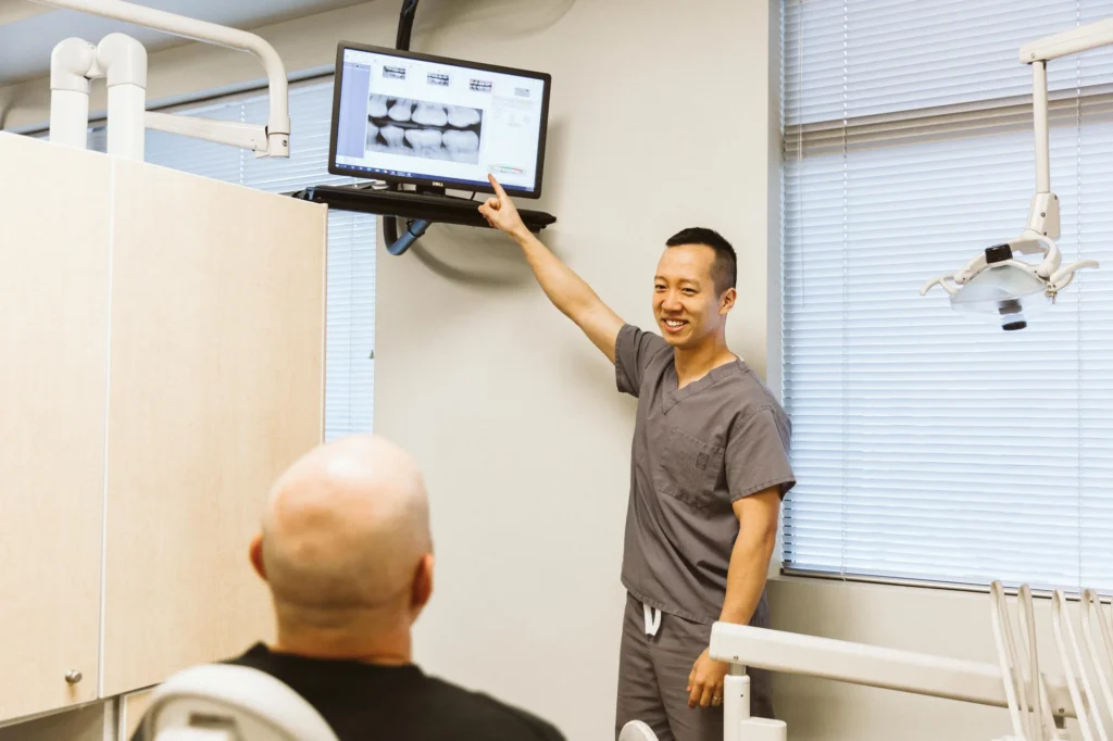 Dr. Cho pointing out details on a patient's digital x-rays on the chairside monitor